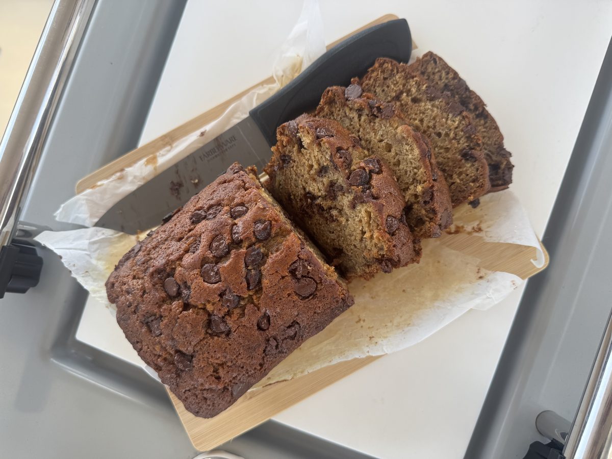 Chocolate chip banana bread loaf, sliced to show melted semisweet chocolate chips throughout
